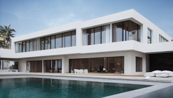 A luxurious white two-story villa with large windows, overlooking an outdoor swimming pool