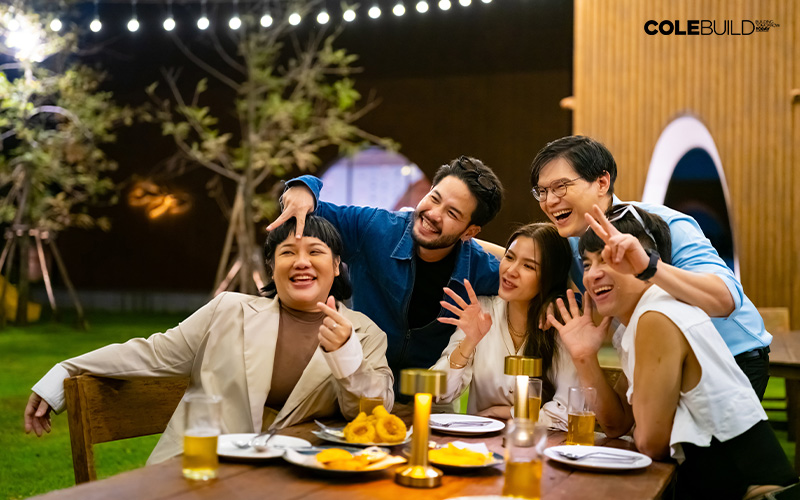 diverse group of people enjoying a meal together in landed property